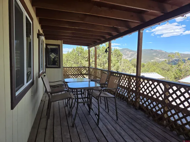 a view of a chairs and table in the balcony