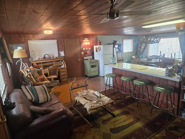 a living room with lots of furniture and a chandelier