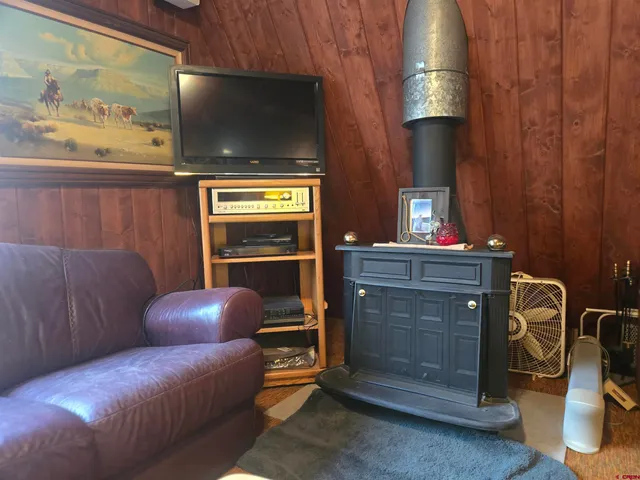 a living room with furniture a flat screen tv and lamp