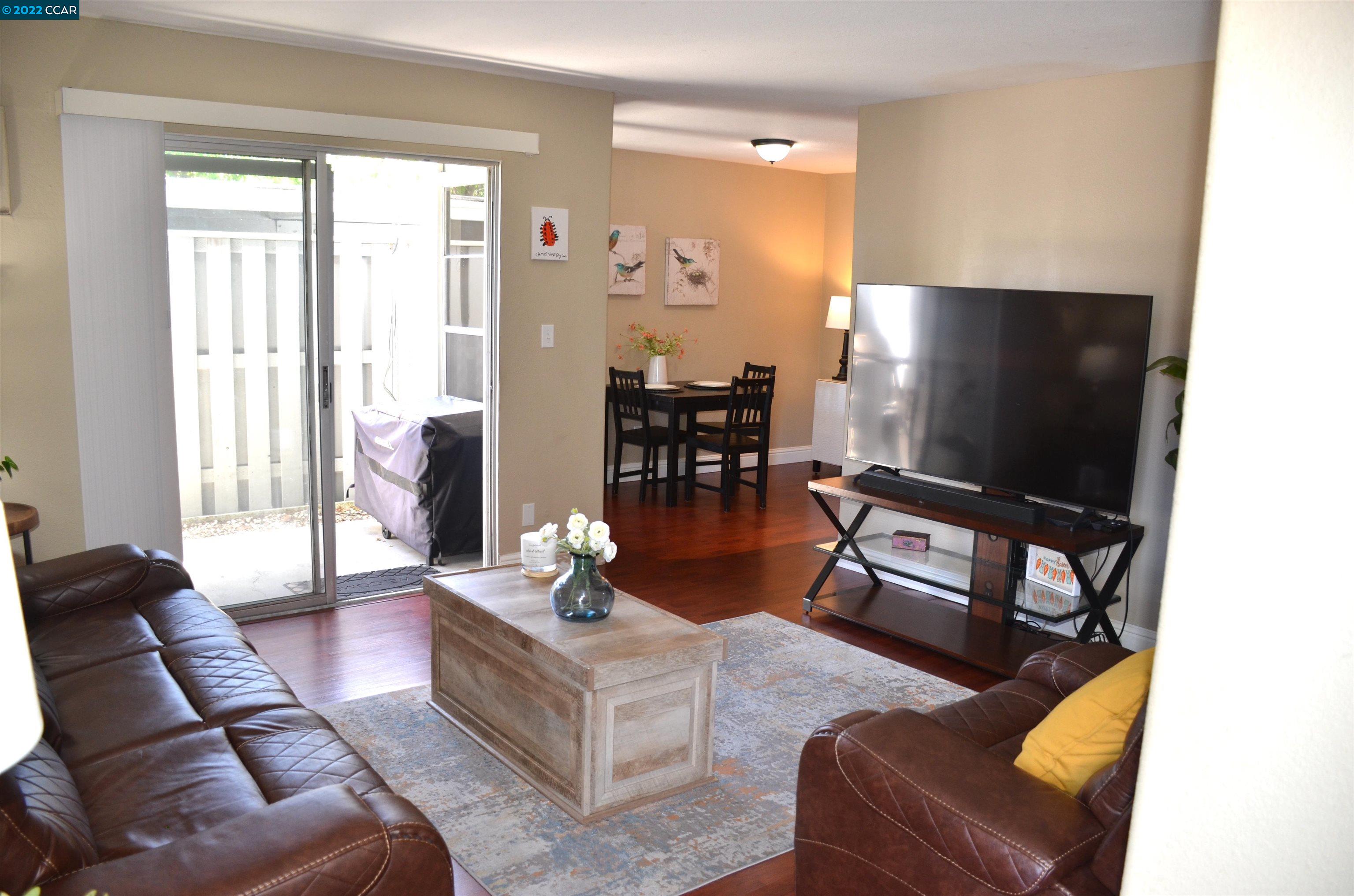 951 Bancroft Road, Unit 109 Concord, CA 94518 - Photo 1 of 1 a living room with furniture and a flat screen tv