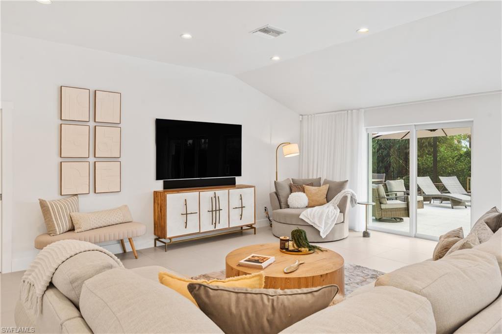 516 Neapolitan Lane Naples, FL 34103 - Photo 10 of 49 Living area with recessed lighting, vaulted ceiling, and light tile patterned floors