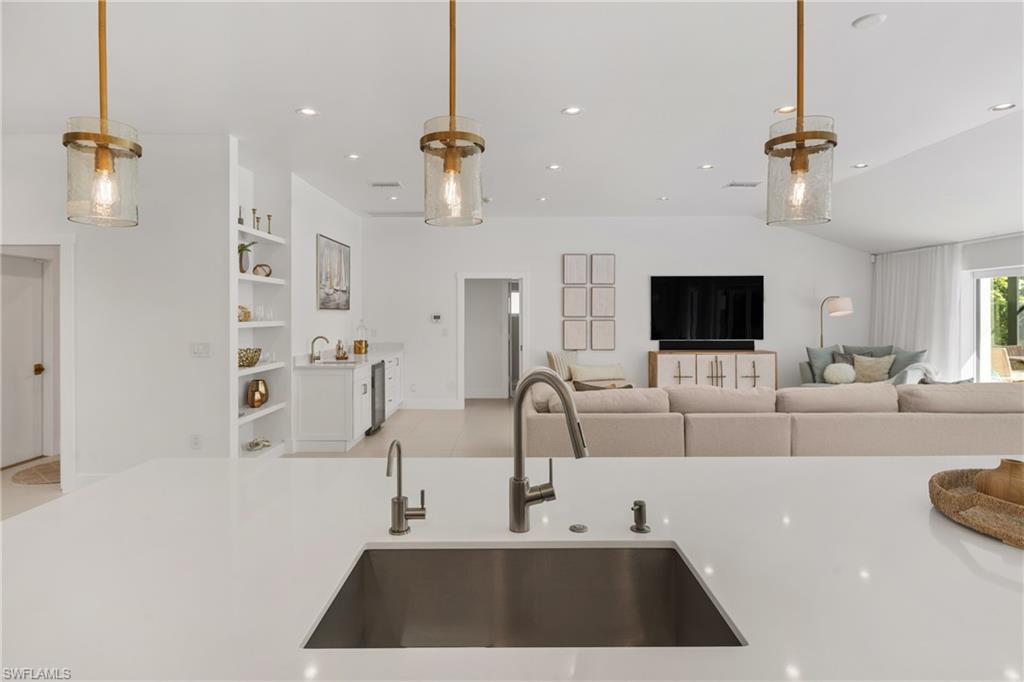 516 Neapolitan Lane Naples, FL 34103 - Photo 49 of 49 Kitchen featuring open floor plan, pendant lighting, recessed lighting, and light stone counters