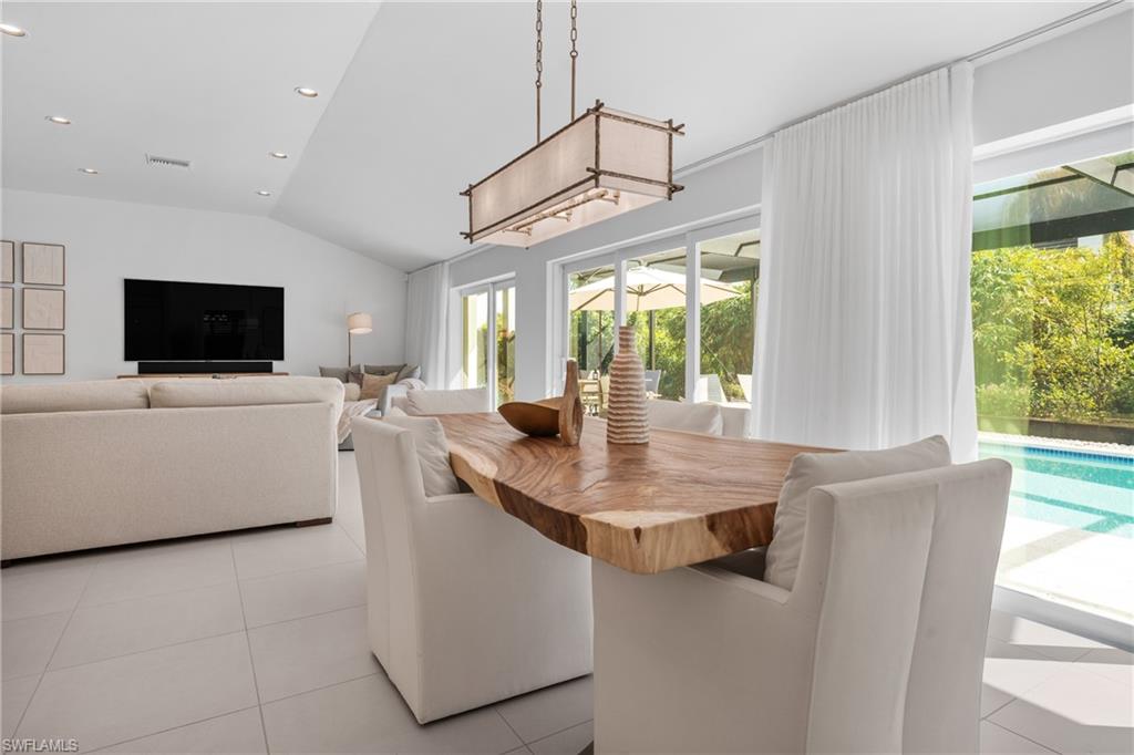 516 Neapolitan Lane Naples, FL 34103 - Photo 13 of 49 Dining room featuring lofted ceiling, light tile patterned floors, and recessed lighting