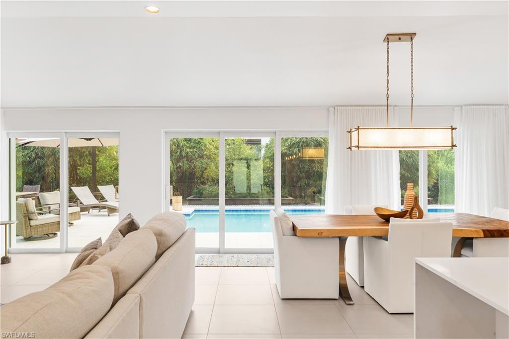 516 Neapolitan Lane Naples, FL 34103 - Photo 15 of 49 Living area with light tile patterned floors and recessed lighting