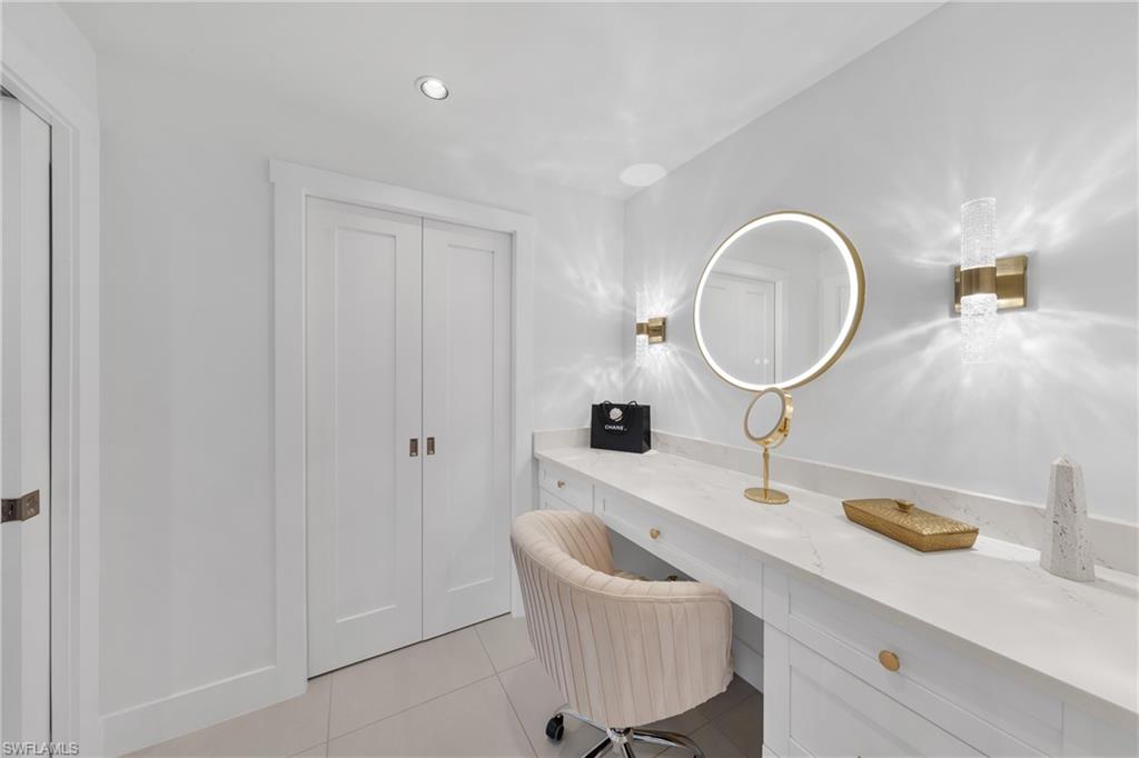 516 Neapolitan Lane Naples, FL 34103 - Photo 19 of 49 Bathroom with light tile patterned floors, vanity, and recessed lighting