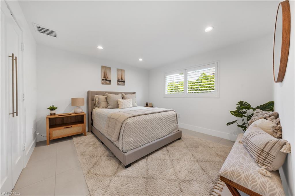 516 Neapolitan Lane Naples, FL 34103 - Photo 24 of 49 Bedroom with light tile patterned floors and recessed lighting