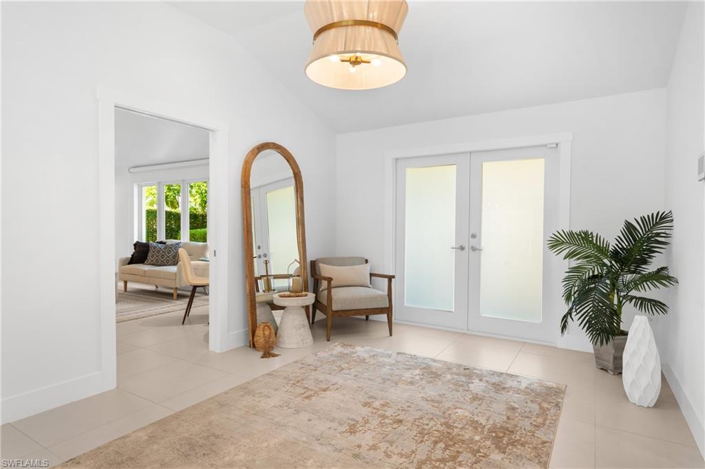 516 Neapolitan Lane Naples, FL 34103 - Photo 28 of 49 Sitting room with french doors, vaulted ceiling, and light tile patterned floors