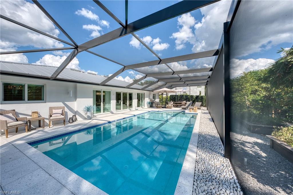 516 Neapolitan Lane Naples, FL 34103 - Photo 31 of 49 Swimming pool with a sunroom, a patio area, and a lanai