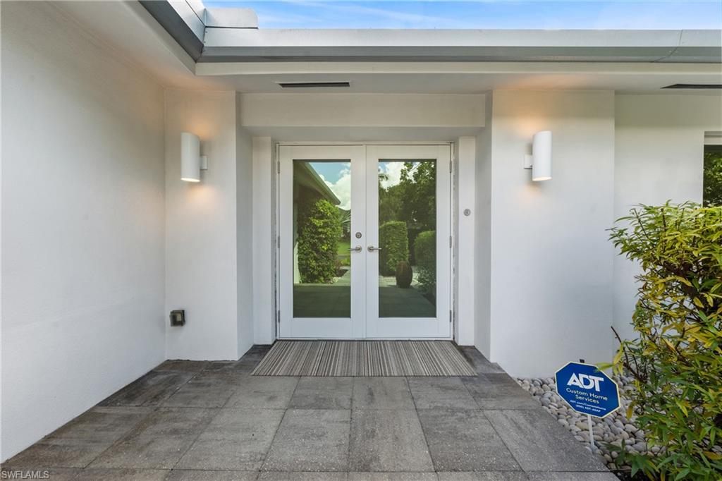 516 Neapolitan Lane Naples, FL 34103 - Photo 44 of 49 Doorway to property with stucco siding, french doors, and a patio area