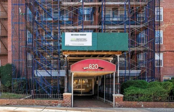 a view of a brick building with a sign on the street