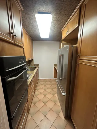 a kitchen with stainless steel appliances a refrigerator and a stove