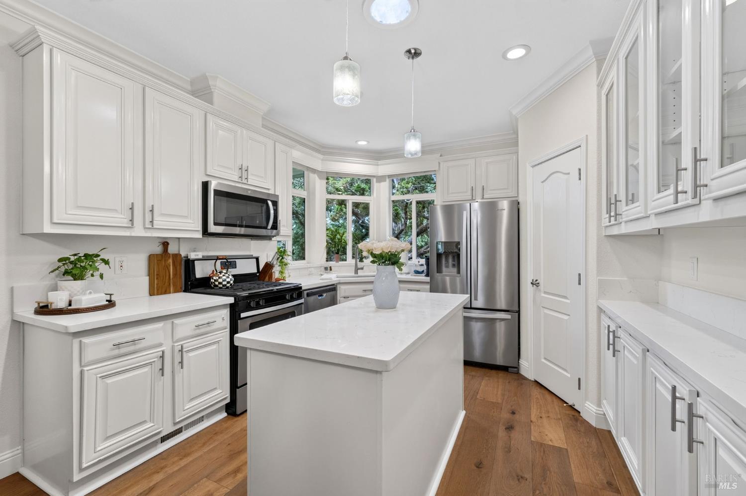 32 Springhill Court Santa Rosa, CA 95409 - Photo 5 of 46 Modern Kitchen with an island, quartz countertops, stainless steel appliances, a pantry, and lots of cabinet space