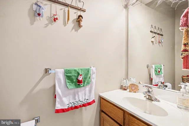 a bathroom with a sink and a white cabinet