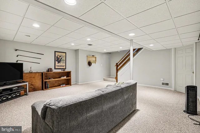 a bed room with furniture and a flat screen tv