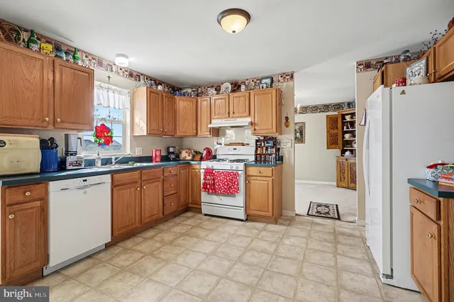 a kitchen with refrigerator and window