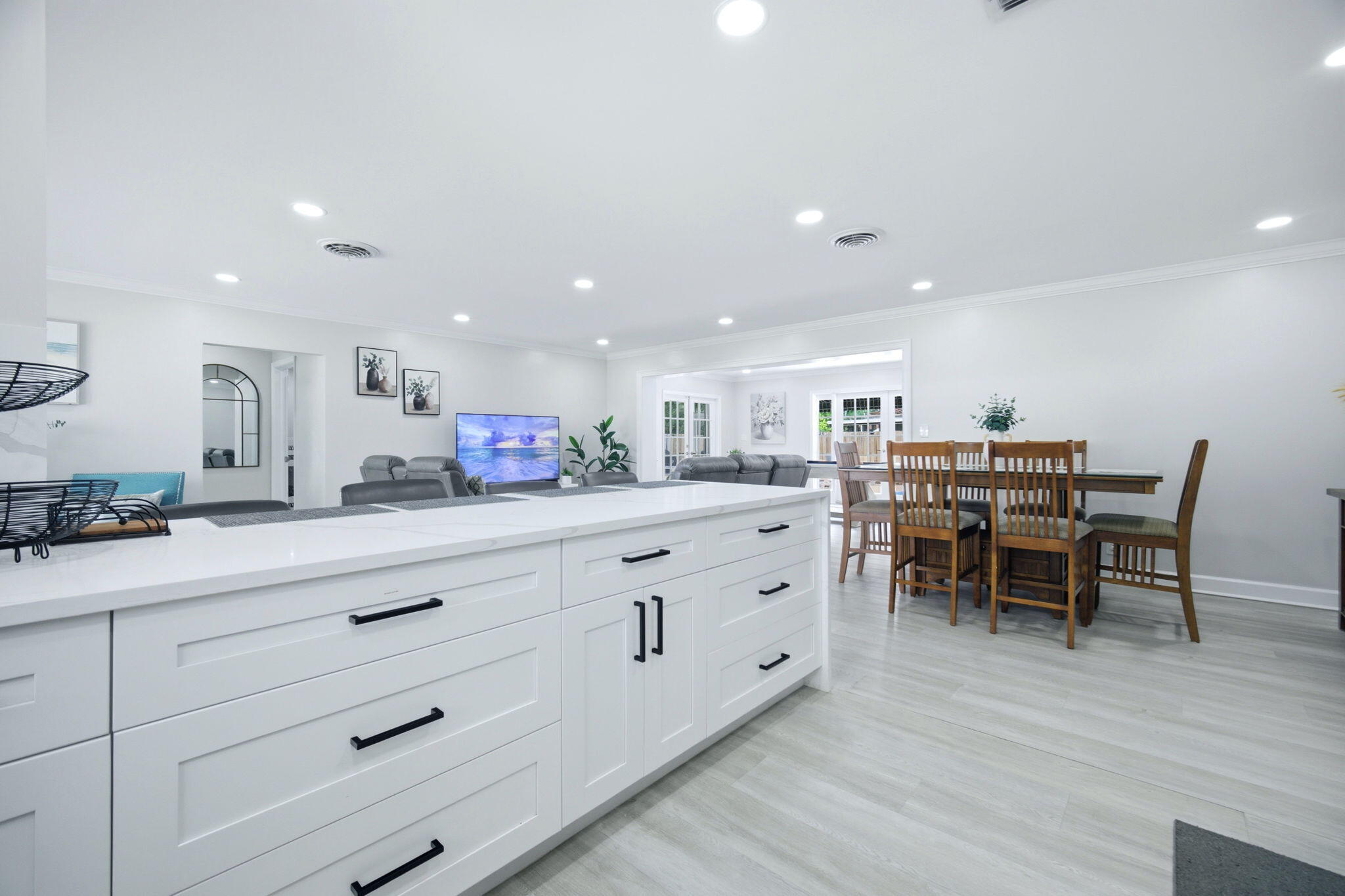 2740 Southeast 7th Street Pompano Beach, FL 33062 - Photo 18 of 34 a kitchen with a dining table chairs and wooden floor