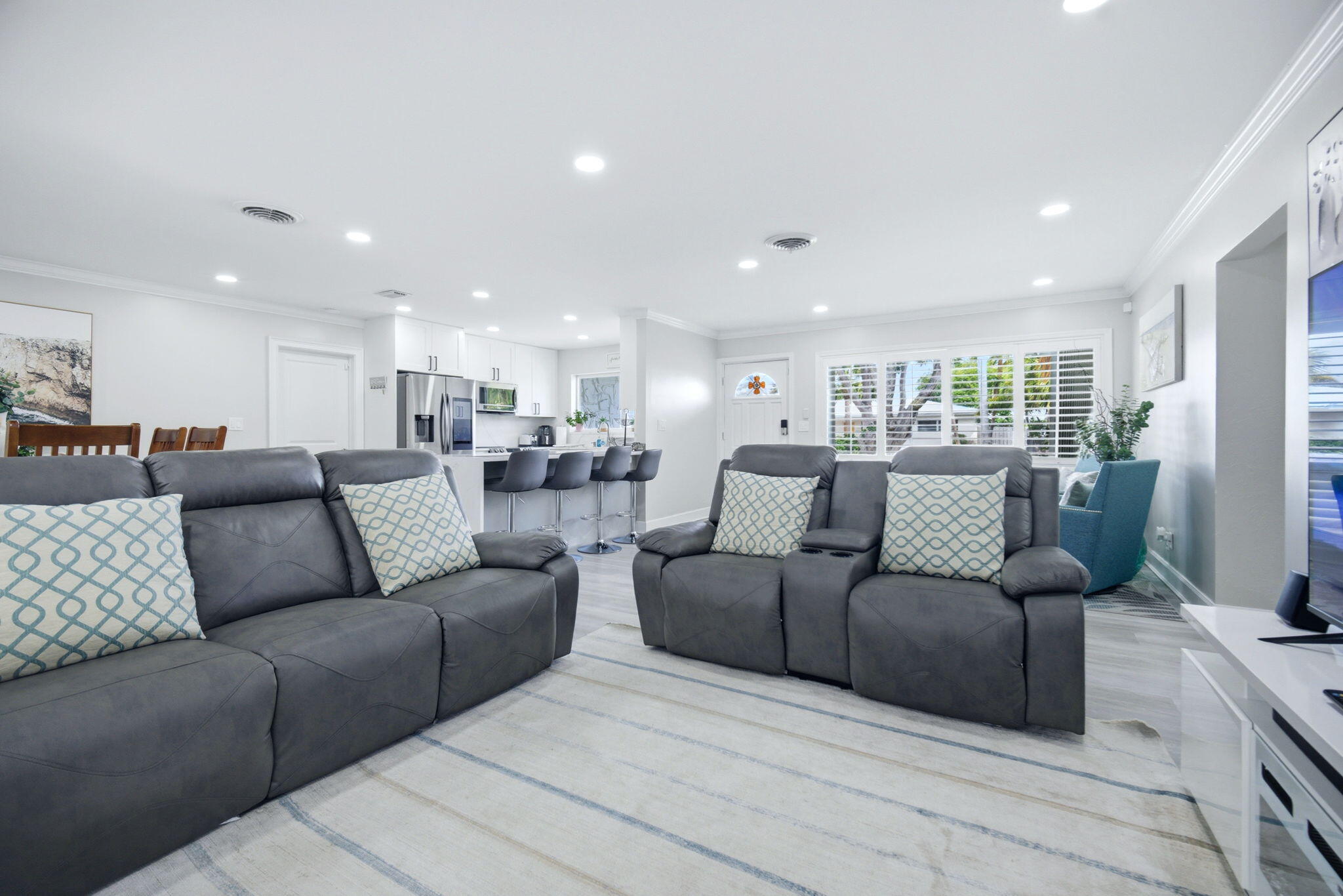2740 Southeast 7th Street Pompano Beach, FL 33062 - Photo 20 of 34 a living room with furniture white walls and a flat screen tv