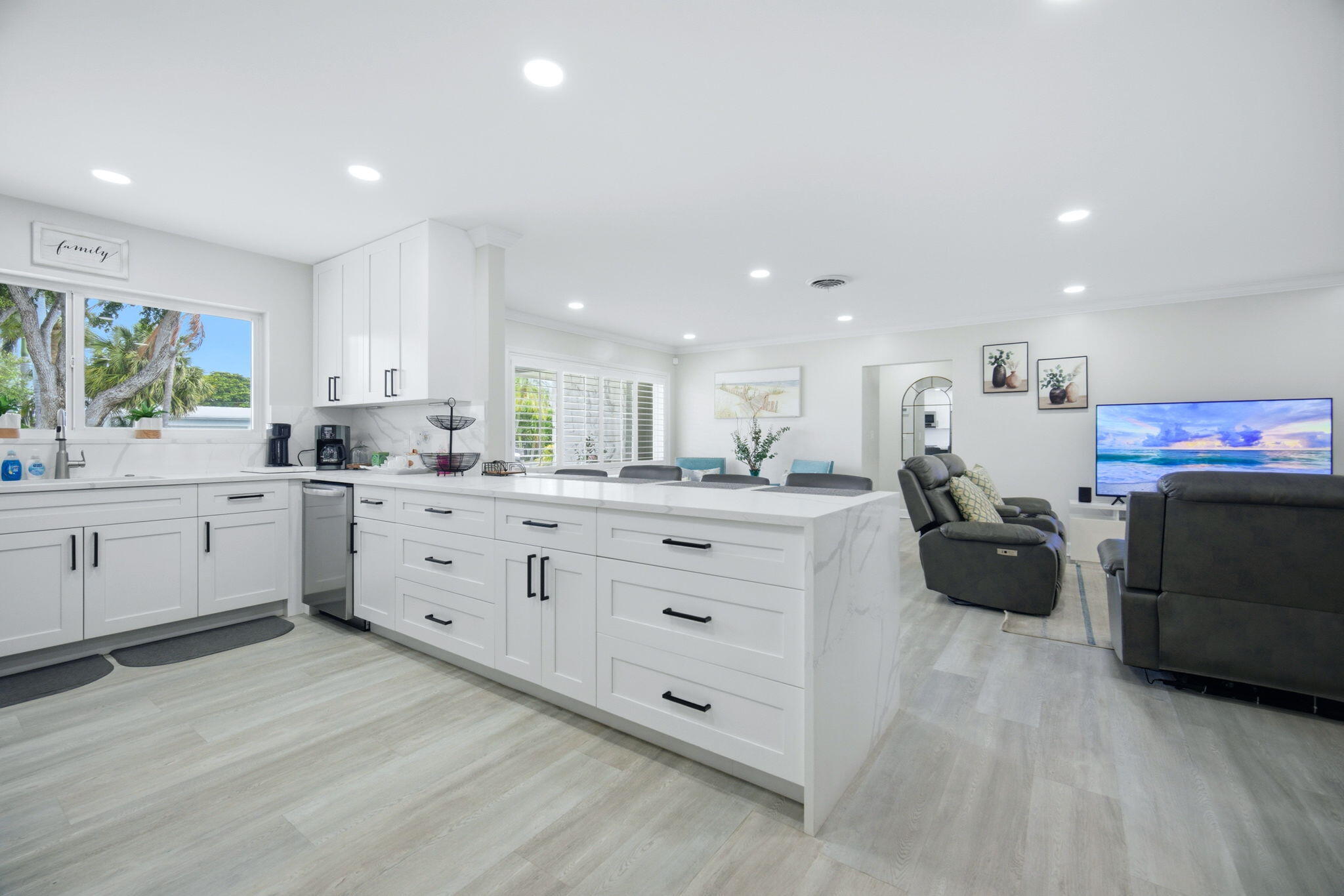 2740 Southeast 7th Street Pompano Beach, FL 33062 - Photo 2 of 34 a kitchen with stainless steel appliances kitchen island granite countertop a refrigerator and white cabinets