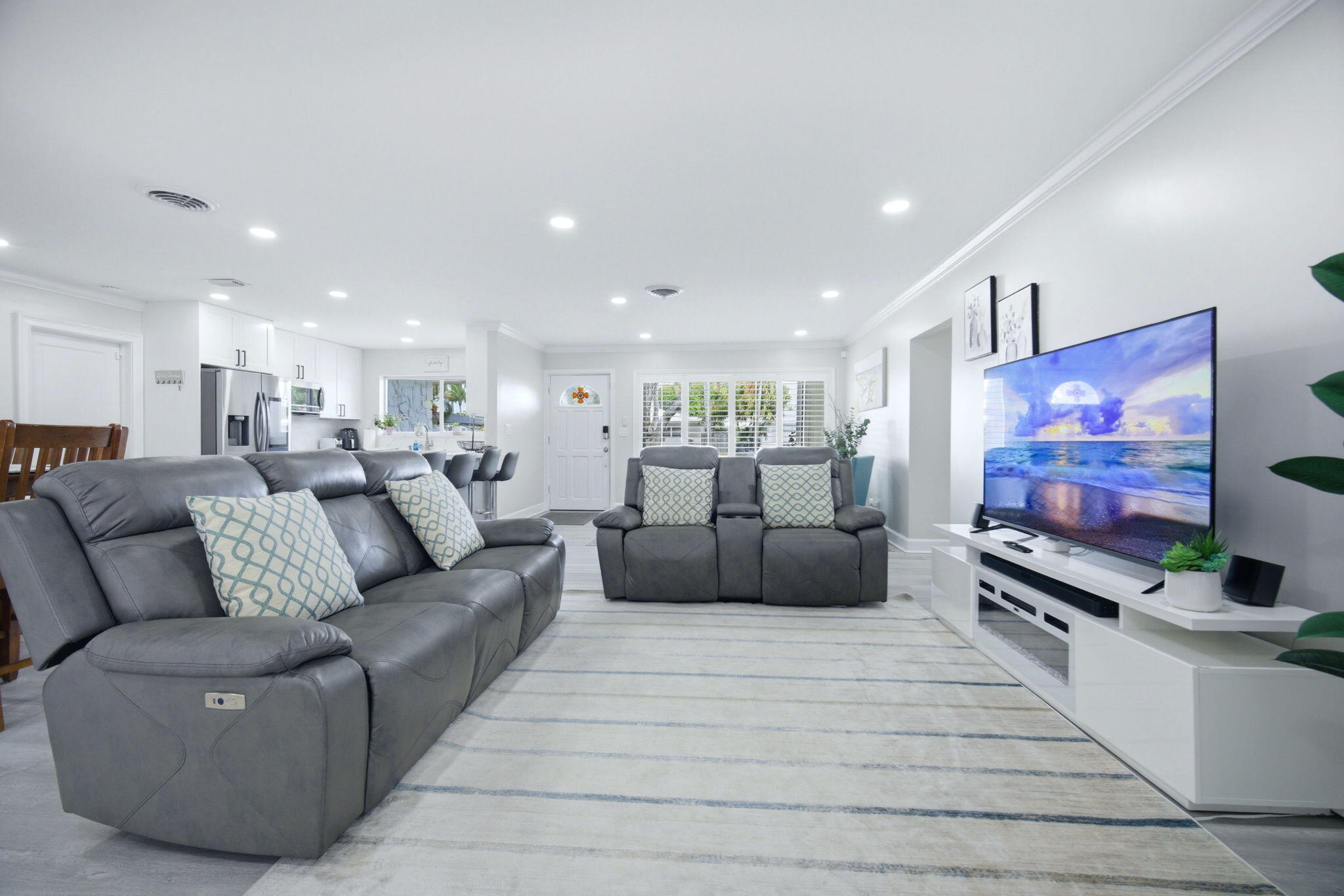 2740 Southeast 7th Street Pompano Beach, FL 33062 - Photo 22 of 34 a living room with furniture and a flat screen tv
