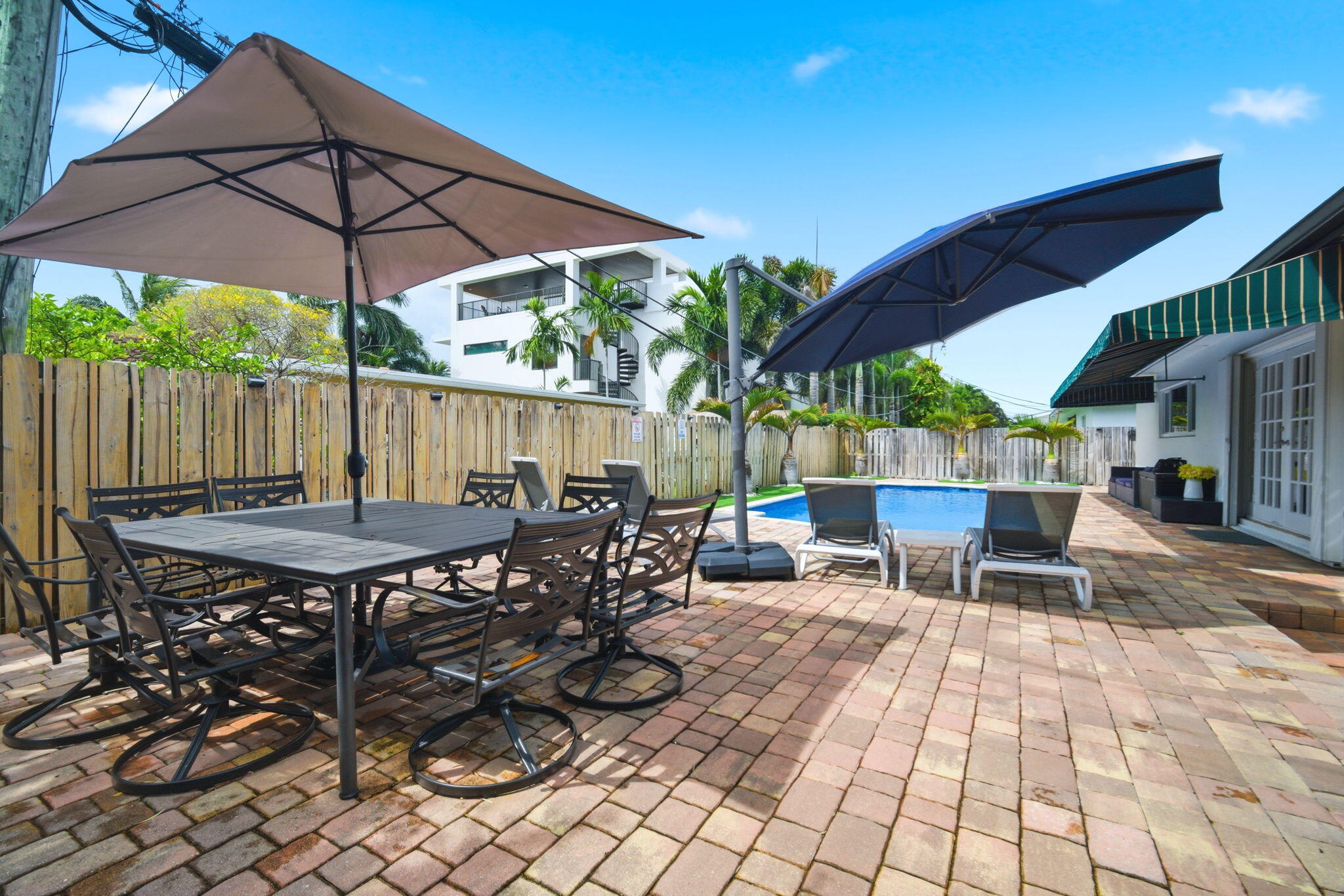 2740 Southeast 7th Street Pompano Beach, FL 33062 - Photo 27 of 34 a view of a patio with table and chairs under an umbrella