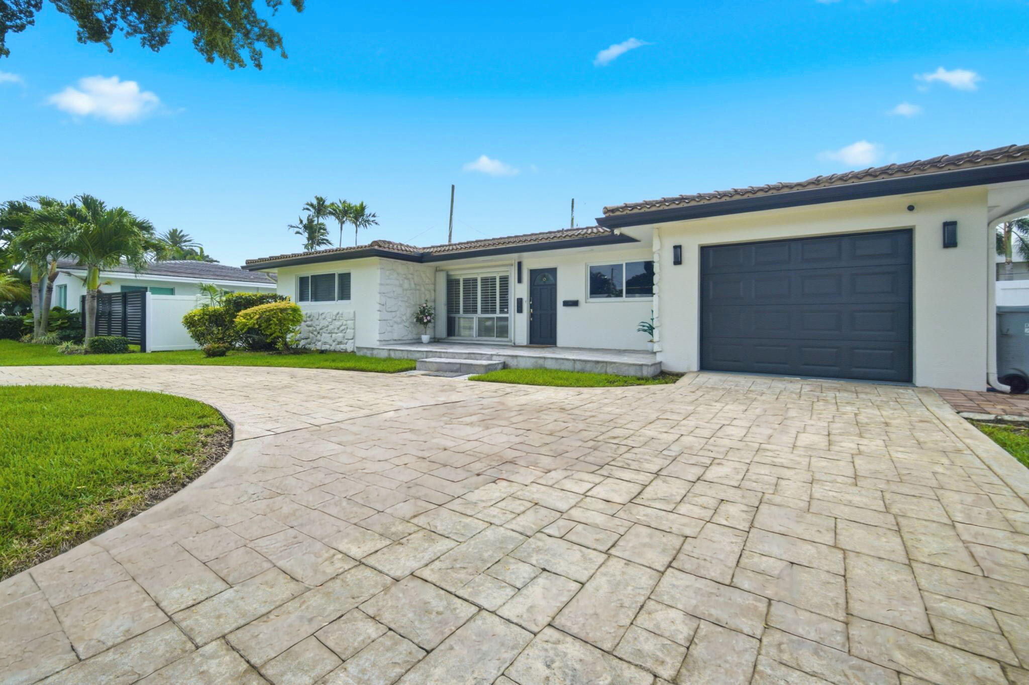 2740 Southeast 7th Street Pompano Beach, FL 33062 - Photo 32 of 34 a front view of a house with a yard and potted plants