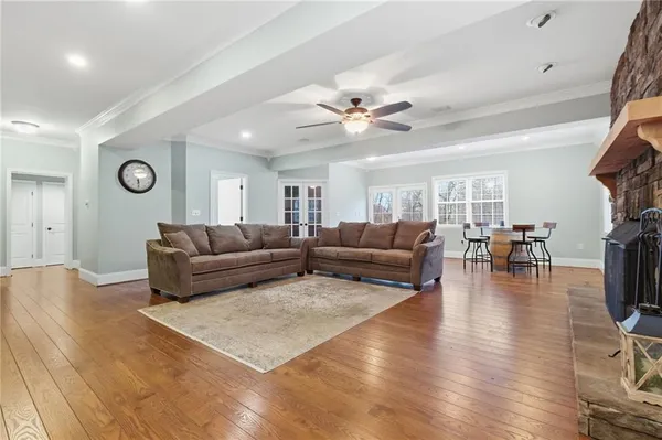a living room with furniture and wooden floor