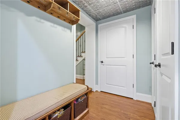 a view of a room with wooden floor and a hallway