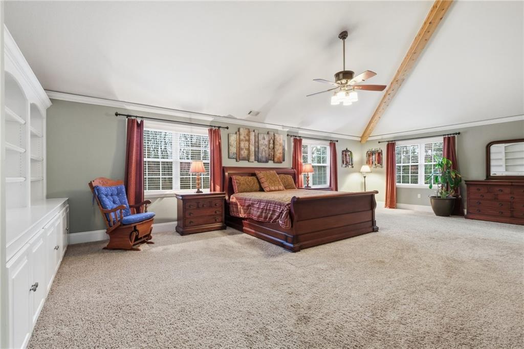 4021 Bakerstown Road Gibsonia, PA 15044 - Photo 26 of 43 a spacious bedroom with a bed a flat screen tv and a couch