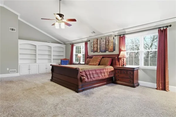 a bedroom with a bed and a large window