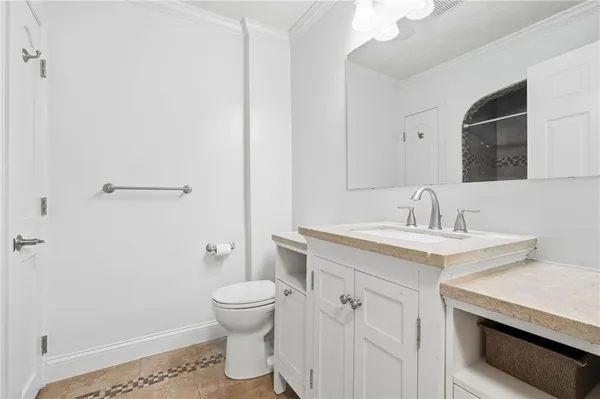 a bathroom with a sink toilet and a mirror