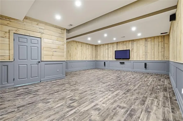 a large kitchen with kitchen island granite countertop sink and cabinets