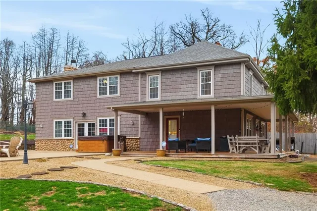 a front view of a house with a yard table and chairs