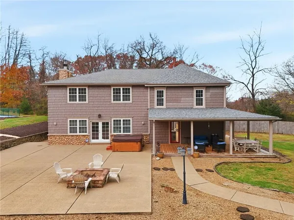 a front view of a house with a yard table and chairs