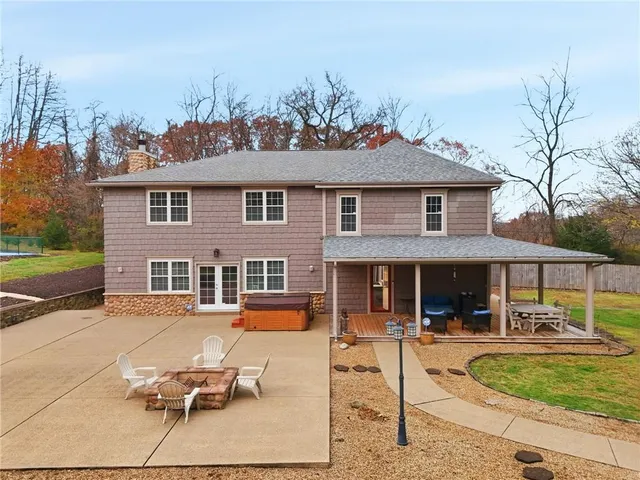 a front view of a house with a yard table and chairs