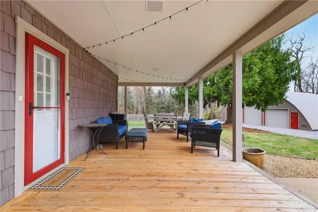 a view of a patio with dining table and chairs
