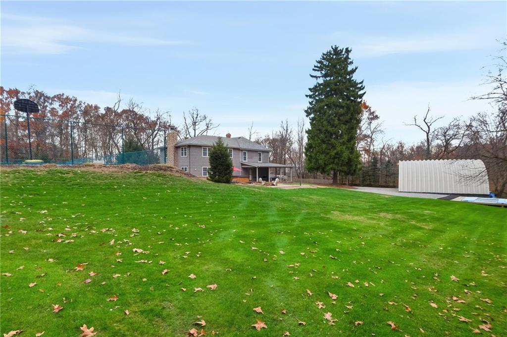 4021 Bakerstown Road Gibsonia, PA 15044 - Photo 41 of 43 a view of a house with a big yard and large trees