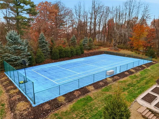 a view of a backyard with large trees