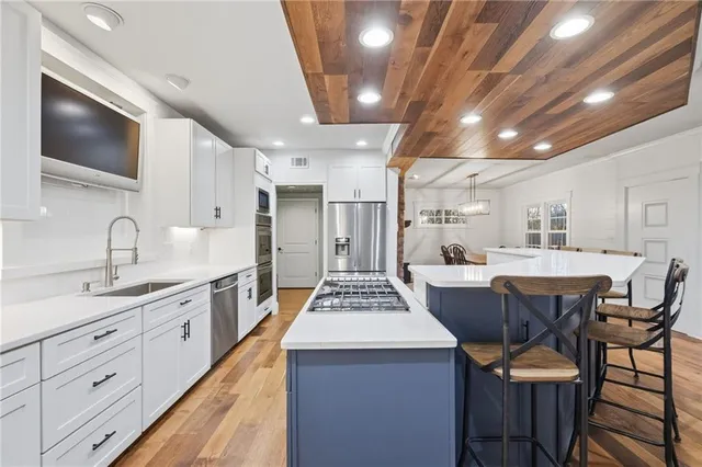 a view of kitchen with sink microwave and cabinets