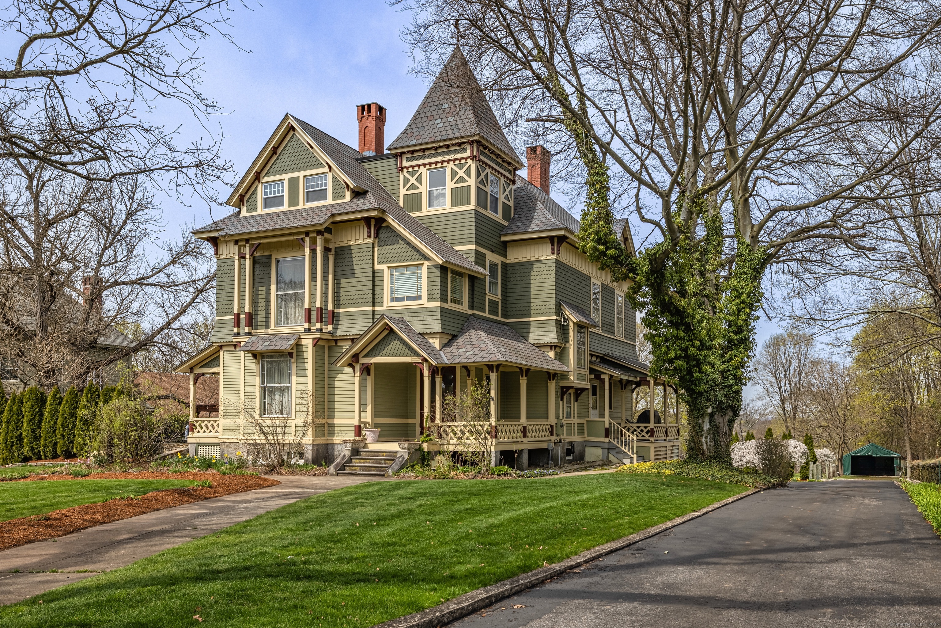 a front view of a residential houses with yard and green space