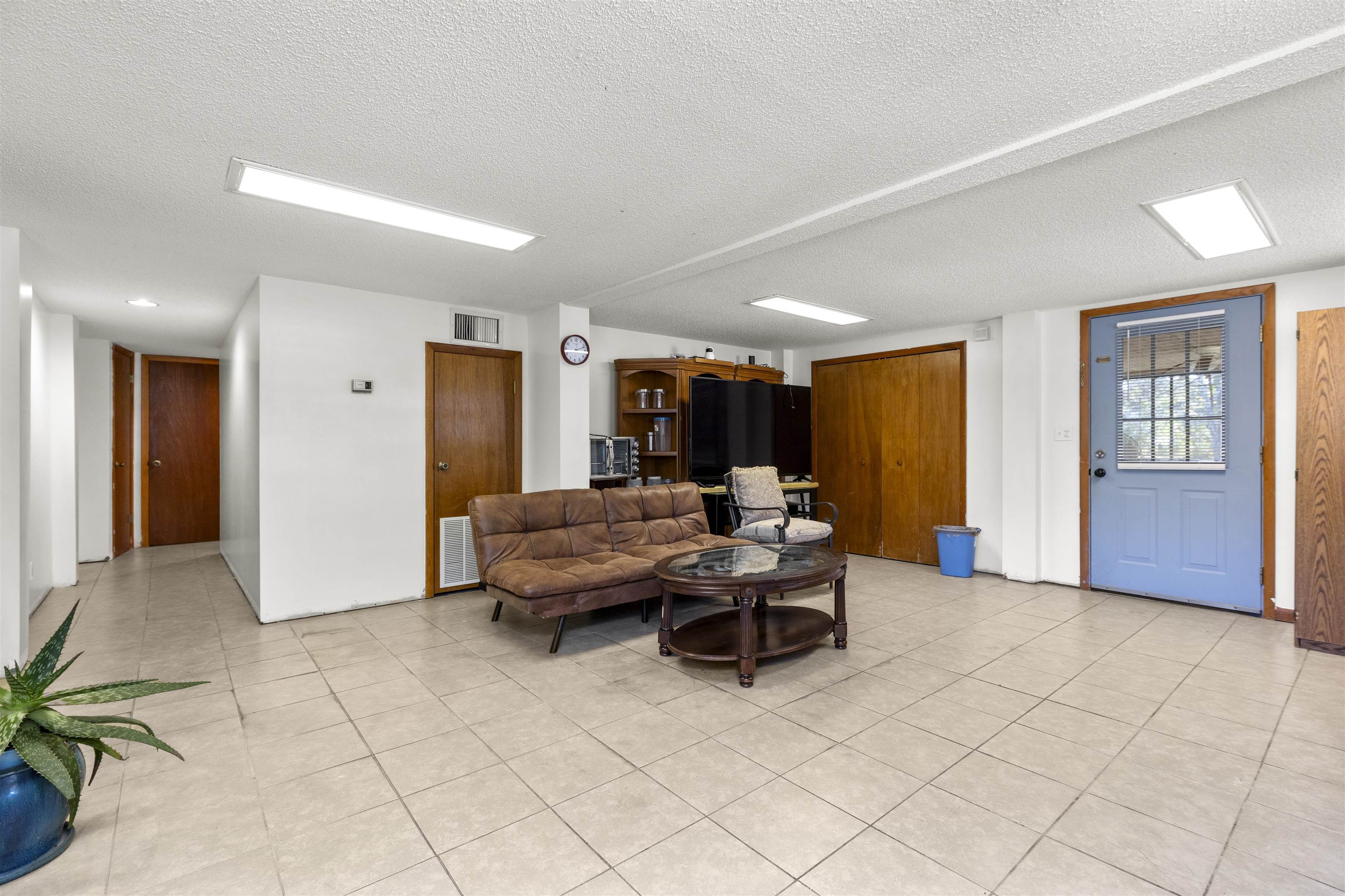 545 Ray Edwards Road St. Augustine, FL 32086 - Photo 12 of 78 Living area featuring a textured ceiling and light tile patterned flooring