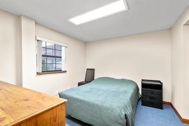 a living room with furniture a flat screen tv and kitchen view