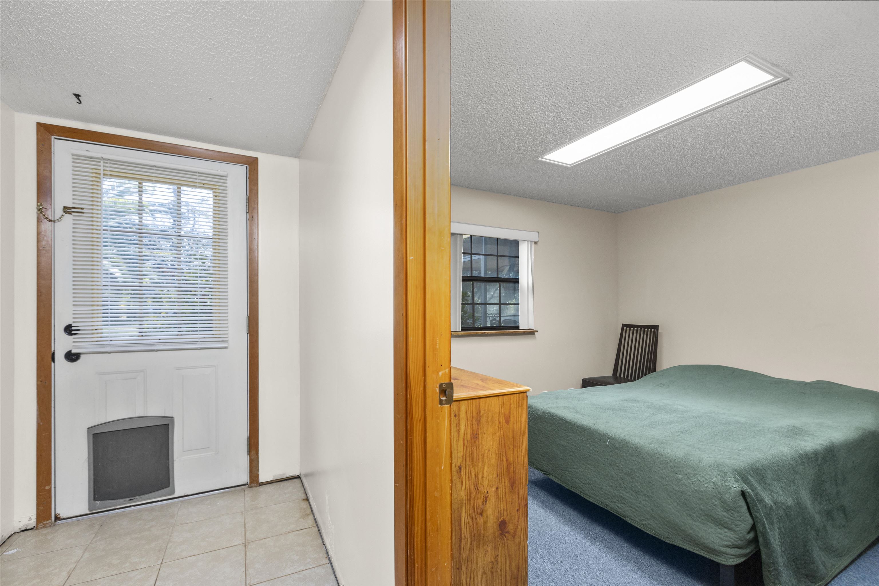545 Ray Edwards Road St. Augustine, FL 32086 - Photo 21 of 78 Tiled bedroom featuring a textured ceiling