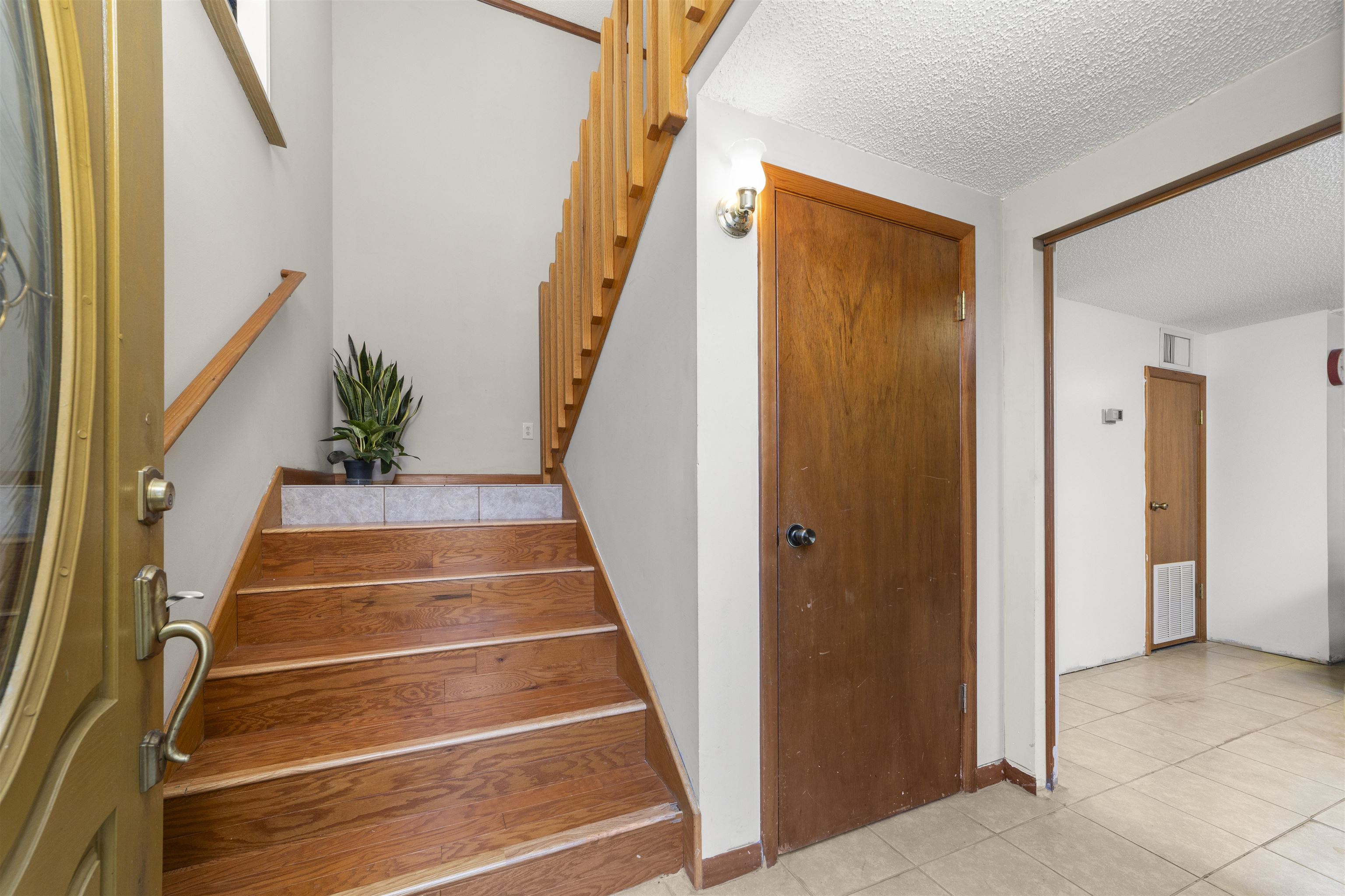 545 Ray Edwards Road St. Augustine, FL 32086 - Photo 22 of 78 Staircase with a textured ceiling and tile patterned flooring