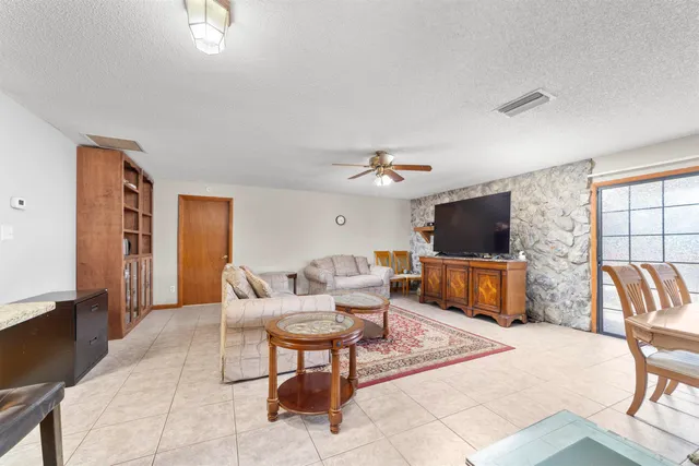 a kitchen with granite countertop appliances a sink cabinets and a window