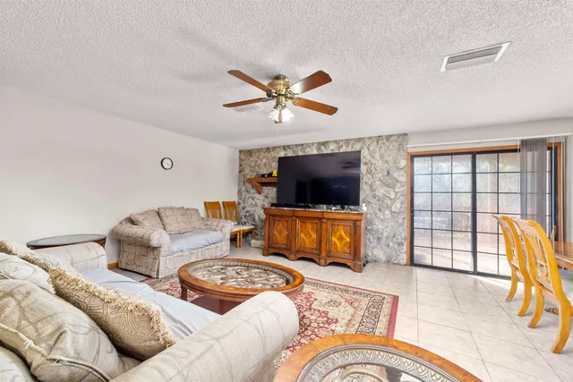 a kitchen with stainless steel appliances granite countertop a refrigerator a sink and wooden cabinets