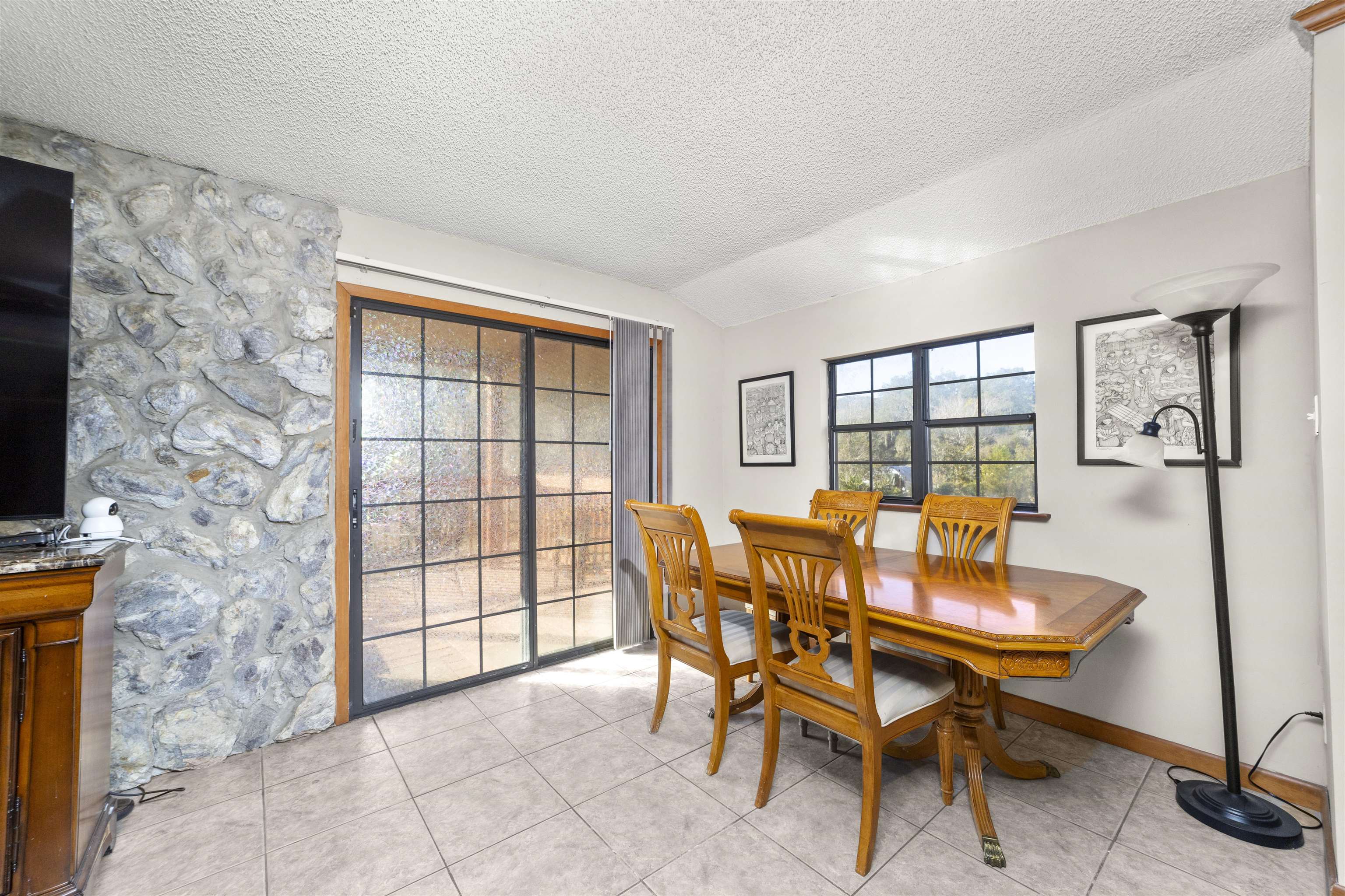 545 Ray Edwards Road St. Augustine, FL 32086 - Photo 27 of 78 Dining room featuring light tile patterned floors, a textured ceiling, and lofted ceiling