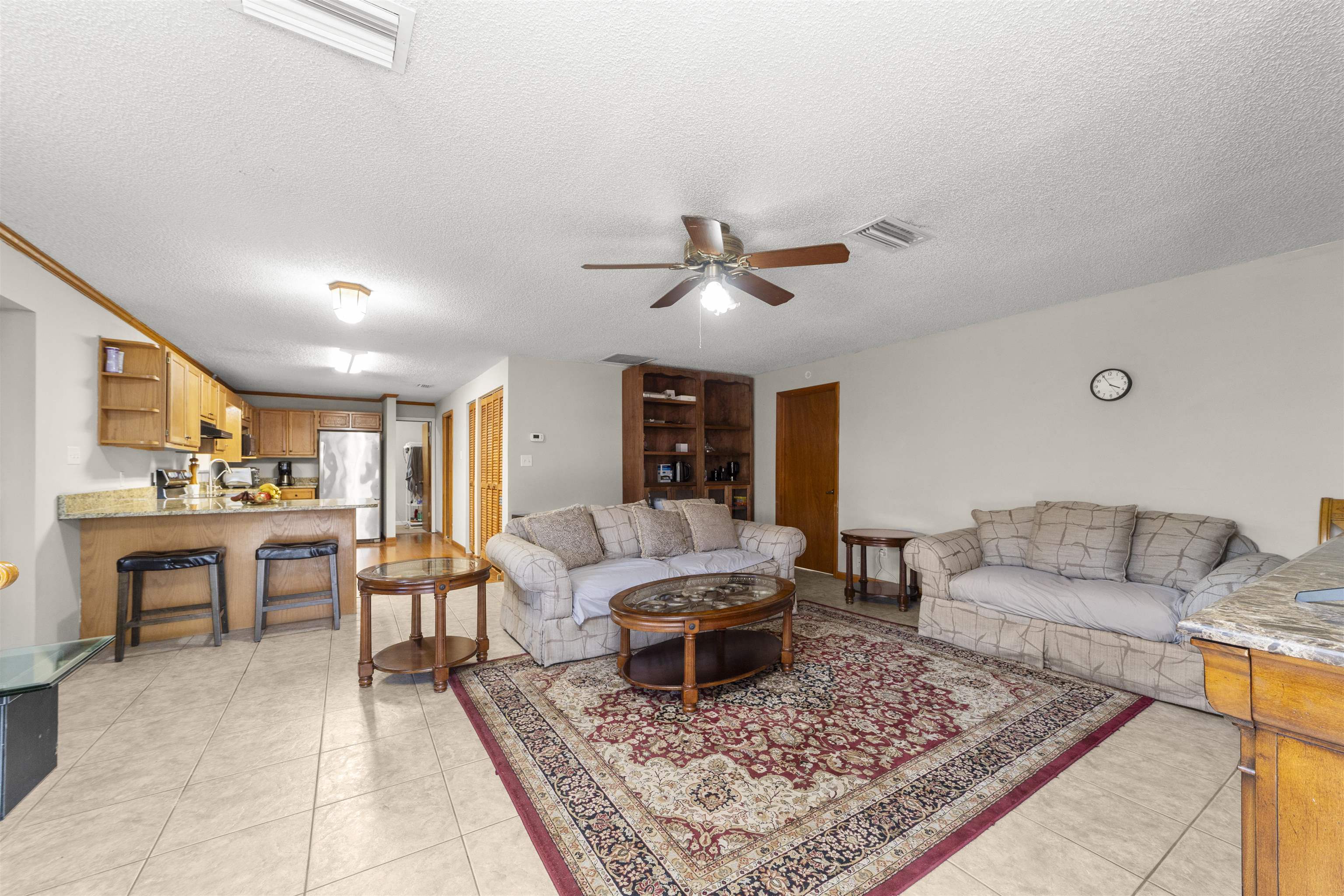 545 Ray Edwards Road St. Augustine, FL 32086 - Photo 28 of 78 Living area with ceiling fan, a textured ceiling, light tile patterned flooring, and built in shelves