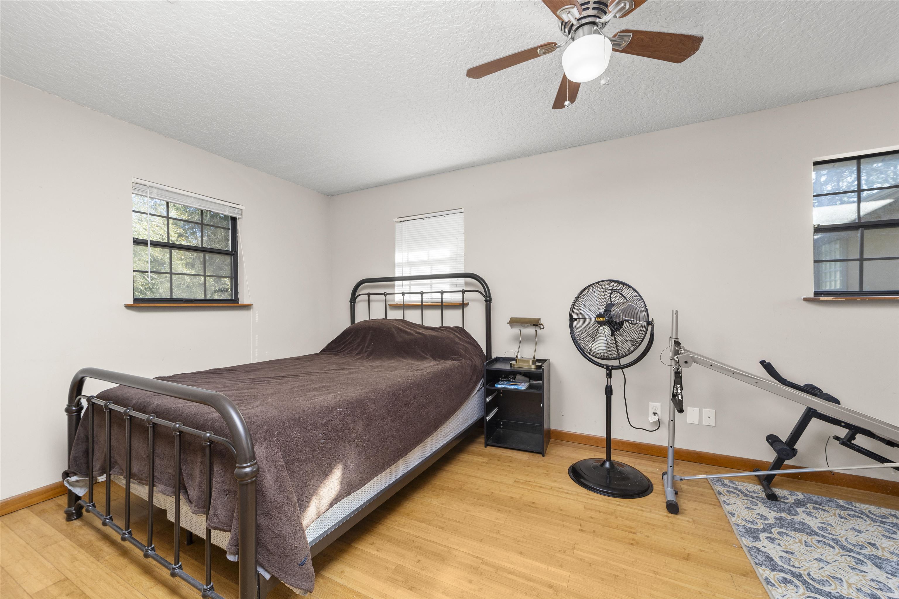 545 Ray Edwards Road St. Augustine, FL 32086 - Photo 34 of 78 Bedroom with light wood-style flooring, a textured ceiling, and ceiling fan