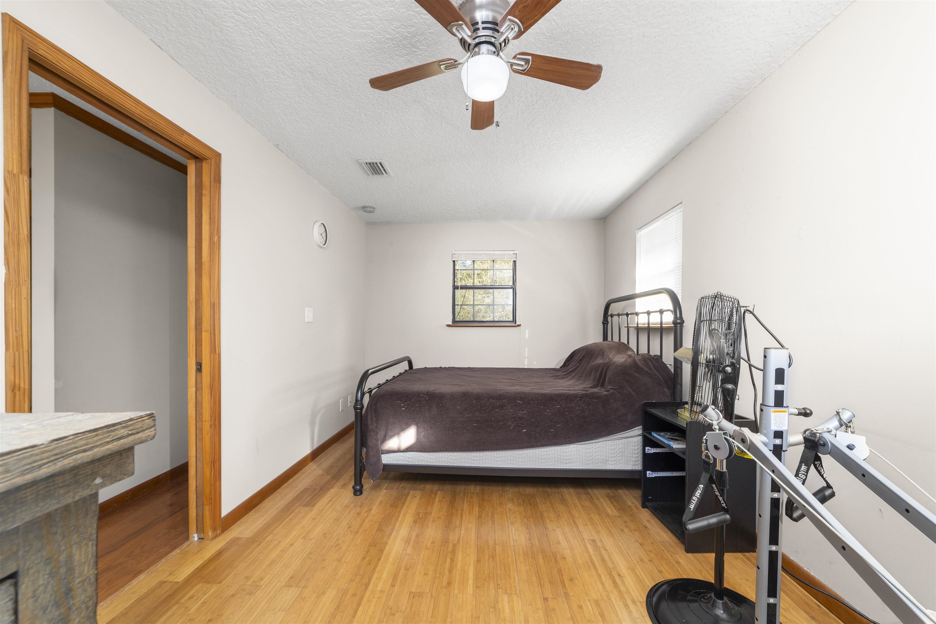 545 Ray Edwards Road St. Augustine, FL 32086 - Photo 35 of 78 Bedroom with a textured ceiling, light wood-type flooring, and a ceiling fan