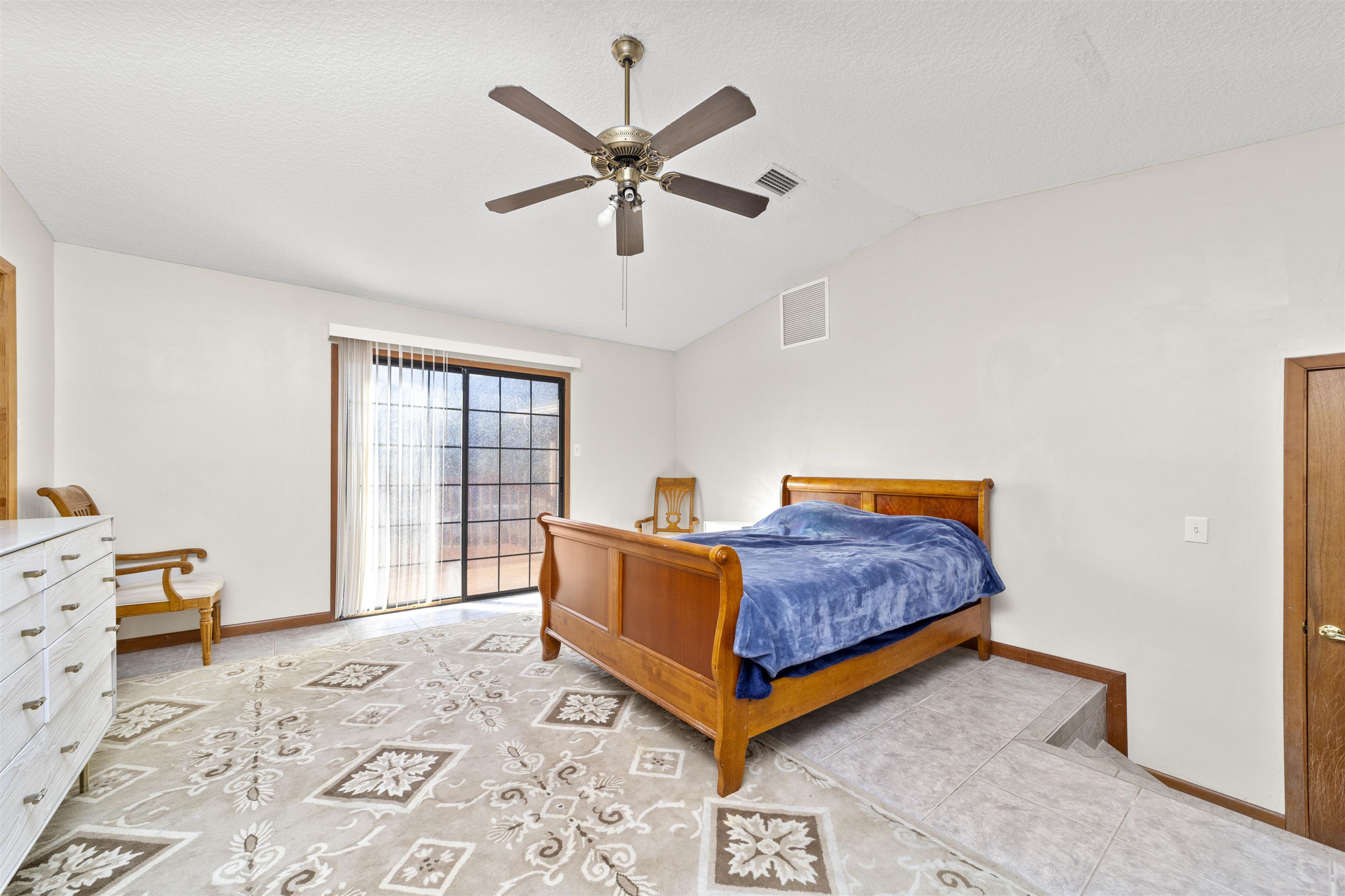 545 Ray Edwards Road St. Augustine, FL 32086 - Photo 38 of 78 Bedroom featuring lofted ceiling, a ceiling fan, and a textured ceiling